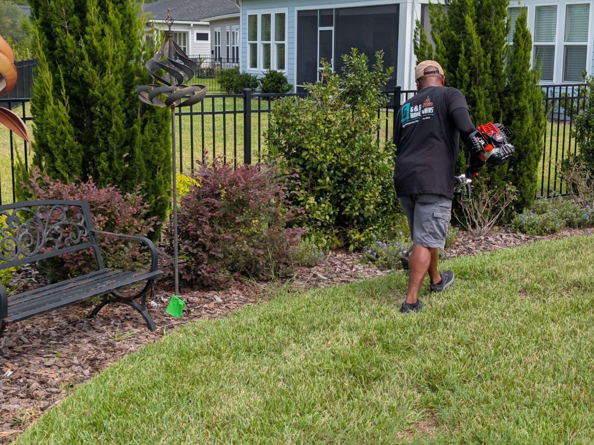 Professional Hedge Trimming & Bed Maintenance - G&G Home Lawns G&G Home Lawns team member performing hedge trimming and landscape bed maintenance at residential home in St. Augustine